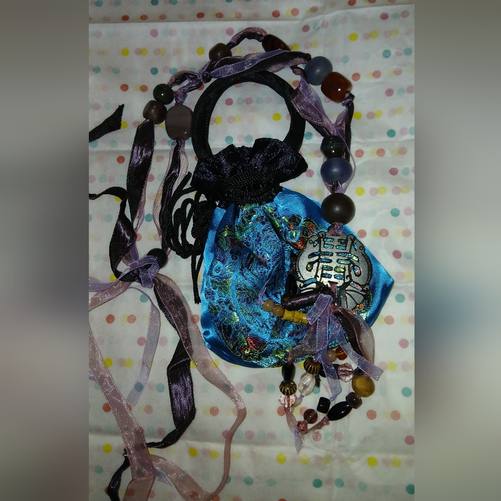 Elegant Beaded Necklace with Intricate Pendant and Bag